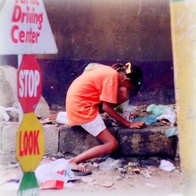 Street girl drinking trash